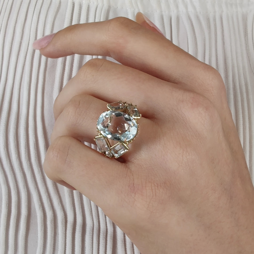 Stunning handcrafted 14K yellow gold cocktail ring with aquamarine gemstones and diamonds, worn on a model’s hand, ideal for Christmas or Black Friday gifts